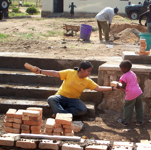 SMU alumna Astrud Villareal helps with a construction project at the Urukundo Home for Children during a Embrey Human Rights Program trip to Rwanda. Photo by Sherry Aikman.